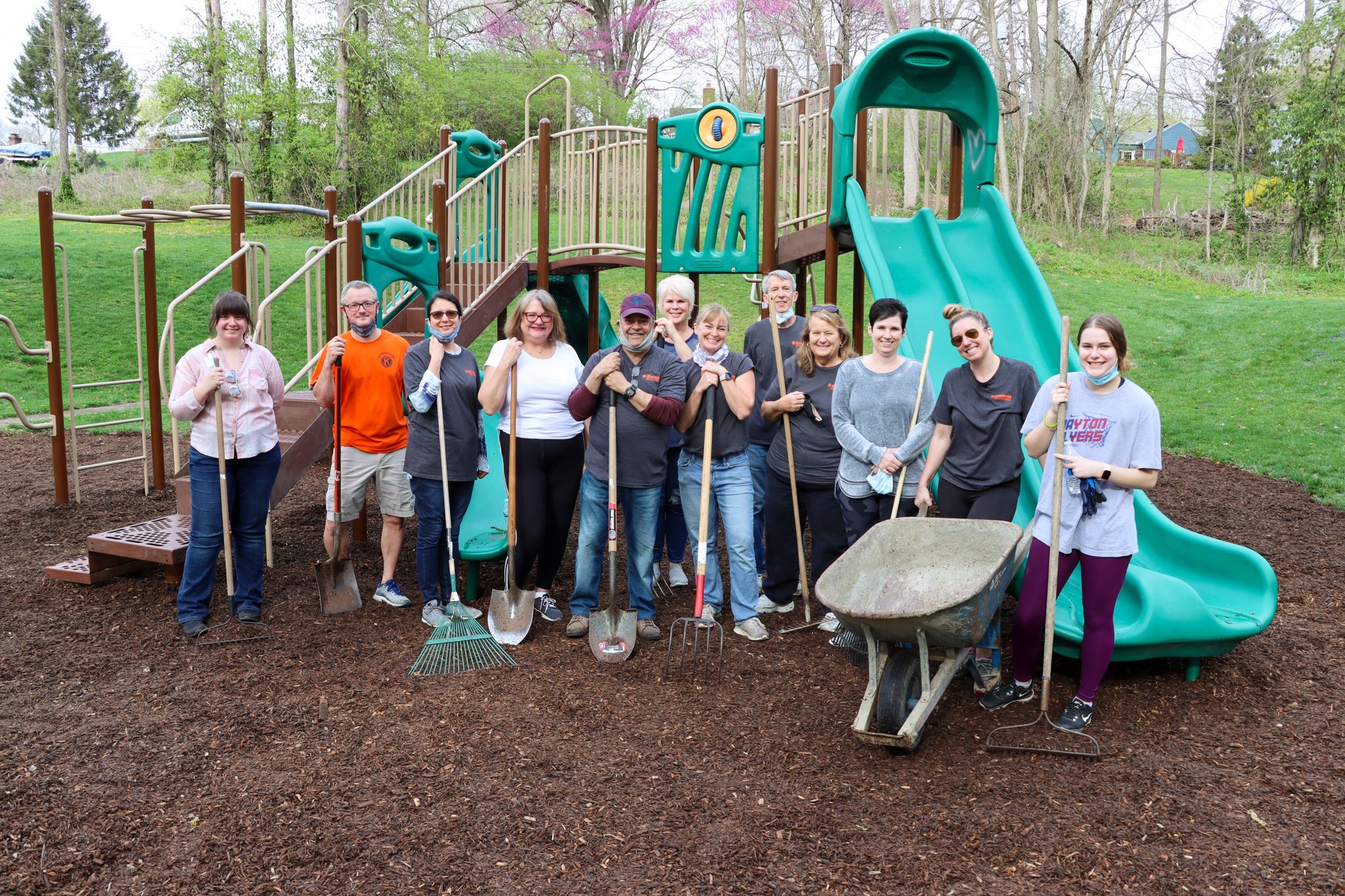 Group of volunteers mulching at city park 