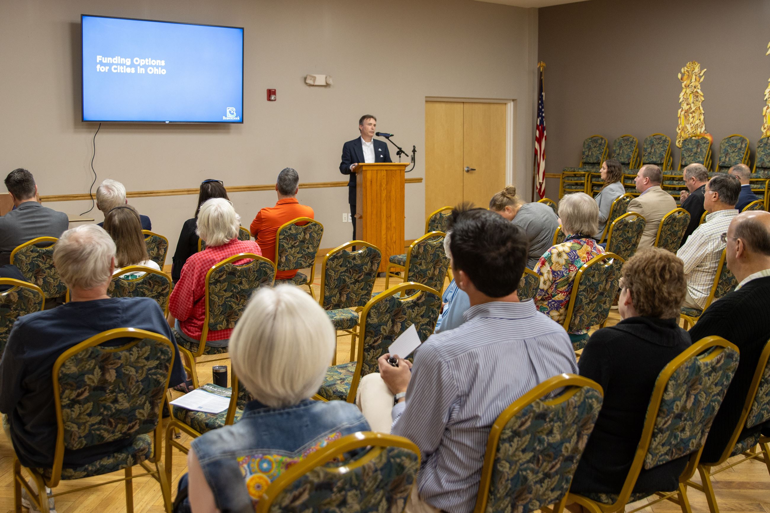 Room full of community members at a city town hall about finances 